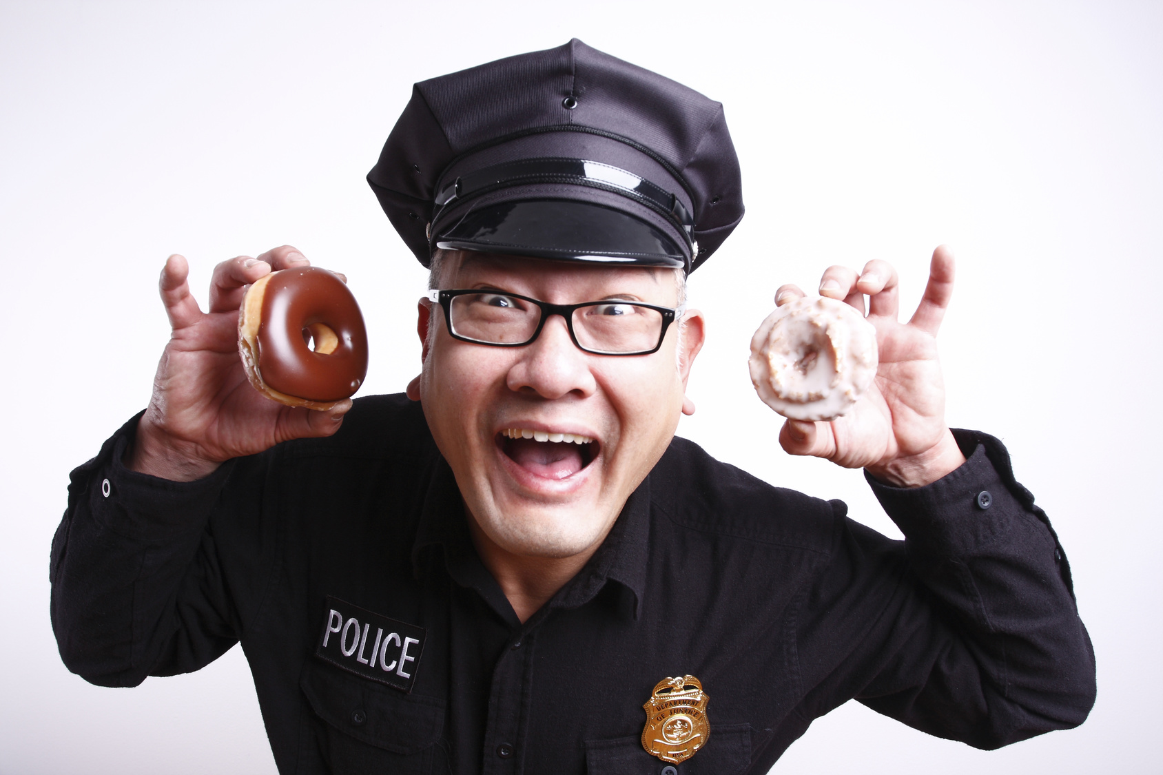 A male police officer with donuts.